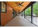 Long covered deck features wood ceiling, ceiling fans, bar area, and outside access at 3095 Champs Way, Mebane, NC 27302