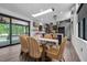 Light-filled dining area with modern table, stylish chairs, and hardwood floors at 3095 Champs Way, Mebane, NC 27302