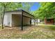 Modern home exterior featuring a covered outdoor area and beautiful landscaping at 3095 Champs Way, Mebane, NC 27302