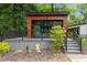 Modern house boasts a deck, black railing and wood facade at 3095 Champs Way, Mebane, NC 27302