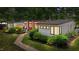 View of home showing gray siding, wood accents, and a stone walkway through manicured landscaping at 3095 Champs Way, Mebane, NC 27302