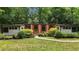 Charming single-story home with lush landscaping and a well-manicured lawn at 3095 Champs Way, Mebane, NC 27302