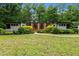 Charming single-story home with lush landscaping and a well-manicured lawn at 3095 Champs Way, Mebane, NC 27302