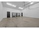 Bright garage with a black door and shelves for storage at 3095 Champs Way, Mebane, NC 27302