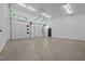 Garage interior showcasing ample space, clean white walls, and natural lighting through windows at 3095 Champs Way, Mebane, NC 27302