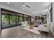 Open living area with hardwood floors, modern furniture, and sliding doors to the outside deck at 3095 Champs Way, Mebane, NC 27302