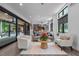 Bright living area with sliding doors to deck, hardwood floors, and views into the modern kitchen at 3095 Champs Way, Mebane, NC 27302