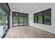 Living room boasts a sliding glass door, recessed lights and wood floors at 3095 Champs Way, Mebane, NC 27302