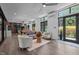 Bright living room boasts hardwood floors, lots of natural light, and contemporary furnishings at 3095 Champs Way, Mebane, NC 27302
