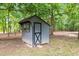 Exterior view of a backyard shed with a black door and window at 3095 Champs Way, Mebane, NC 27302