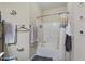 Bright bathroom features a shower/tub combo with tile surround and neutral tones at 320 Madres Ln, Morrisville, NC 27560