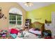 The sun shines into the bedroom showing off the bright paint and large window at 320 Madres Ln, Morrisville, NC 27560