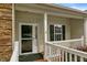 Cozy front porch with a secure glass door and white railing offers a private entrance at 320 Madres Ln, Morrisville, NC 27560