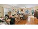 Open-concept living and dining area featuring hardwood floors, windows, and natural light at 320 Madres Ln, Morrisville, NC 27560