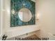 Stylish powder room with a round mirror and a herringbone tile backsplash at 3422 Redbud Ln, Raleigh, NC 27607