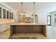 Spacious kitchen featuring a large island, marble countertops, and modern lighting at 3422 Redbud Ln, Raleigh, NC 27607