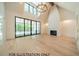 Bright living room featuring a fireplace, hardwood floors, and large windows at 3422 Redbud Ln, Raleigh, NC 27607