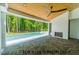 Covered patio with stone floors, fireplace, outdoor ceiling fan and views of the swimming pool at 3422 Redbud Ln, Raleigh, NC 27607