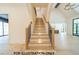Elegant staircase featuring wood treads, iron balusters, and recessed lighting at 3422 Redbud Ln, Raleigh, NC 27607