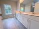Bathroom featuring a double sink vanity, tile floors, and large window offering natural light at 356 Beacon Hill Rd # 103, Lillington, NC 27546