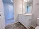 A well-lit bathroom features a single vanity and a glimpse into an adjoining carpeted room at 356 Beacon Hill Rd # 103, Lillington, NC 27546