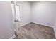 Clean bedroom with wood-look floors and a glass panel door leading to another room at 356 Beacon Hill Rd # 103, Lillington, NC 27546