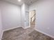 Neutral bedroom featuring wood-look floors and a glass panel door leading to a carpeted stairway at 356 Beacon Hill Rd # 103, Lillington, NC 27546