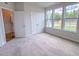 Bedroom featuring carpeted floors, closet, and bright windows at 356 Beacon Hill Rd # 103, Lillington, NC 27546