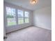 Bright bedroom with three large windows offering a view of the outdoors at 356 Beacon Hill Rd # 103, Lillington, NC 27546