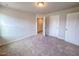 A cozy bedroom with neutral walls and carpet, featuring two doors and a ceiling light at 356 Beacon Hill Rd # 103, Lillington, NC 27546