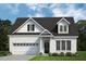 Charming, light brick two-story home featuring a front-entry two car garage and classic dormer windows at 356 Beacon Hill Rd # 103, Lillington, NC 27546