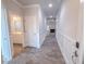 Hallway with wood-look floors, white molding, and views of the bathroom and living room at 356 Beacon Hill Rd # 103, Lillington, NC 27546