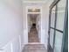 Hallway with wood-look floors, white molding, and a view of the living room at 356 Beacon Hill Rd # 103, Lillington, NC 27546