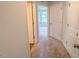 Hallway featuring neutral carpet and walls and an open doorway with a view to the exterior at 356 Beacon Hill Rd # 103, Lillington, NC 27546