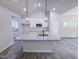 Kitchen island with granite countertops and stylish pendant lighting brightens this modern kitchen at 356 Beacon Hill Rd # 103, Lillington, NC 27546