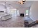 Open-concept living room boasts modern fireplace, ceiling fan, and gray wood-look flooring at 356 Beacon Hill Rd # 103, Lillington, NC 27546