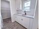 Pantry area features white cabinets, granite countertops and a metal storage rack at 356 Beacon Hill Rd # 103, Lillington, NC 27546