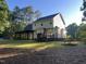View of home's exterior, including a spacious backyard with a covered porch and deck at 395 Wyndham Place Dr, Fuquay Varina, NC 27526