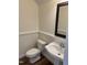Charming powder room with pedestal sink, decorative mirror, and classic fixtures at 395 Wyndham Place Dr, Fuquay Varina, NC 27526