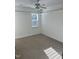 Cozy bedroom with natural light, ceiling fan, and neutral carpet, offering a comfortable retreat at 395 Wyndham Place Dr, Fuquay Varina, NC 27526