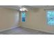 Bedroom with neutral walls, carpet, and two windows providing natural light at 395 Wyndham Place Dr, Fuquay Varina, NC 27526