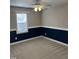 Bedroom featuring neutral carpet, blue accent wall, and ceiling fan with light at 395 Wyndham Place Dr, Fuquay Varina, NC 27526