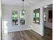 Light-filled dining room features wood floors, updated lighting, and an open layout to the kitchen at 395 Wyndham Place Dr, Fuquay Varina, NC 27526