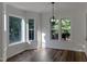 Bright dining area with wood flooring, a modern chandelier, and large windows with backyard views at 395 Wyndham Place Dr, Fuquay Varina, NC 27526