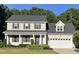 Charming two-story home featuring a landscaped front yard, inviting entrance, and attached garage at 395 Wyndham Place Dr, Fuquay Varina, NC 27526