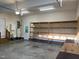 Spacious garage with ample shelving and storage space, plus a utility sink and water heater at 395 Wyndham Place Dr, Fuquay Varina, NC 27526