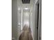 Hallway with wood floors and multiple doors leading to various rooms, providing easy access throughout the home at 395 Wyndham Place Dr, Fuquay Varina, NC 27526