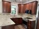 Well-equipped kitchen features stainless steel appliances, granite countertops, and custom wood cabinetry at 395 Wyndham Place Dr, Fuquay Varina, NC 27526