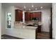 Modern kitchen featuring granite counters, stainless steel appliances, custom cabinetry, and lots of light at 395 Wyndham Place Dr, Fuquay Varina, NC 27526