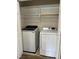 Convenient laundry area featuring modern washer and dryer, with ample shelving for storage at 395 Wyndham Place Dr, Fuquay Varina, NC 27526